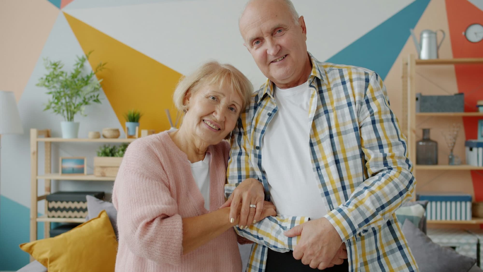 A retired couple smiling at home