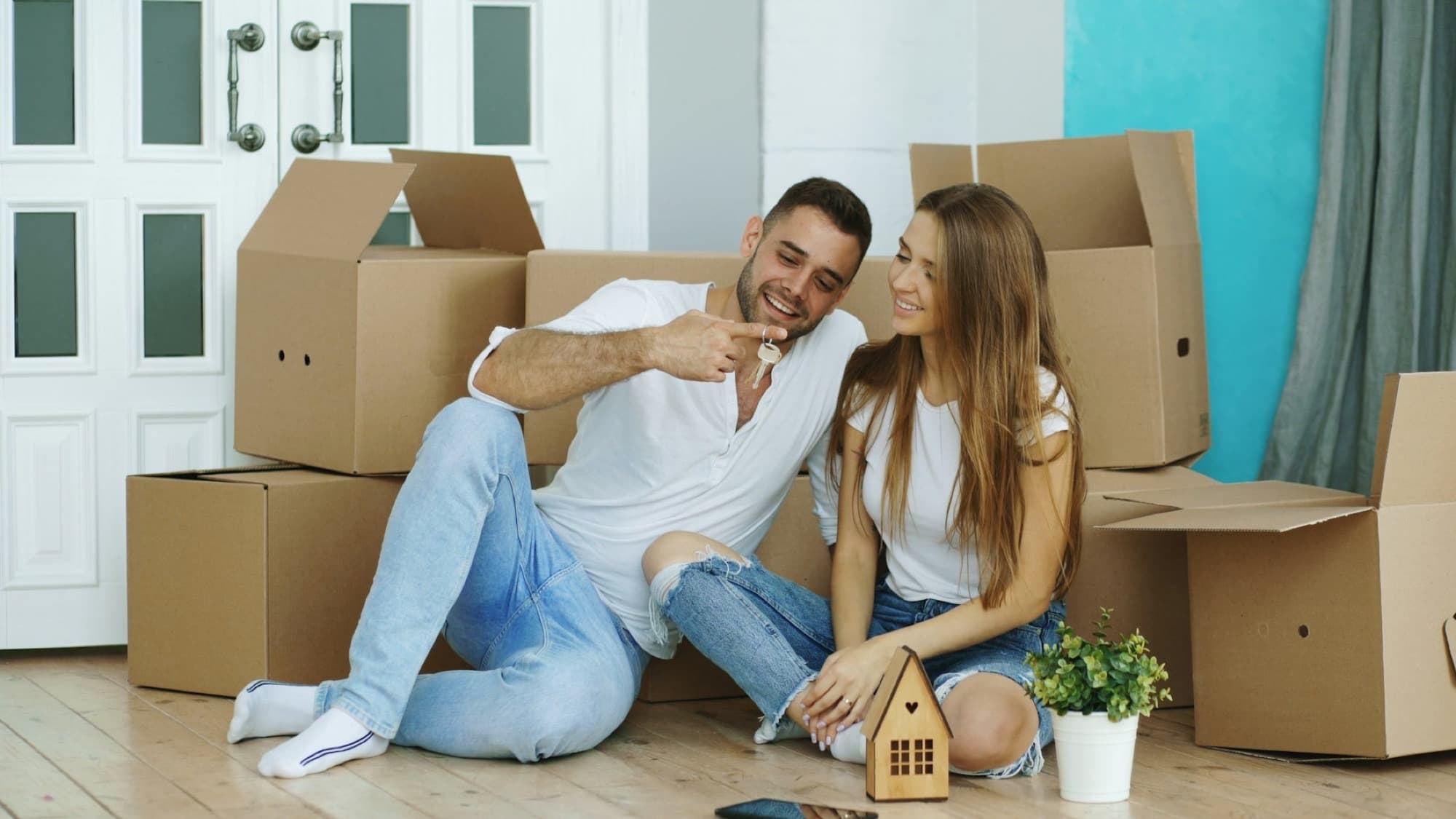 A young couple in their new home among moving boxes