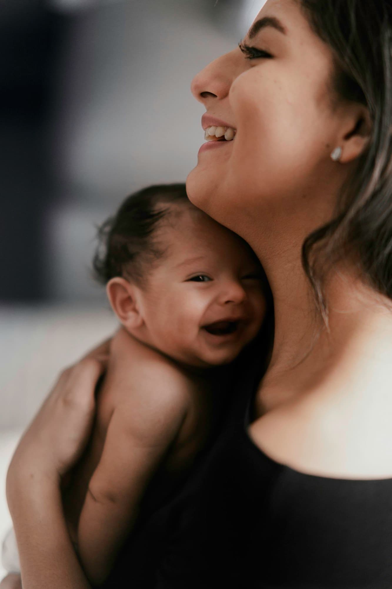 A mother holding her laughing baby